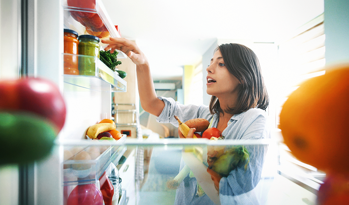 Woman grabbing food from the fridge
