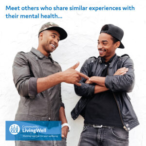 two men smiling and talking during a social peer support group